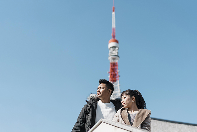 low angle couple enjoying city view with antenna back